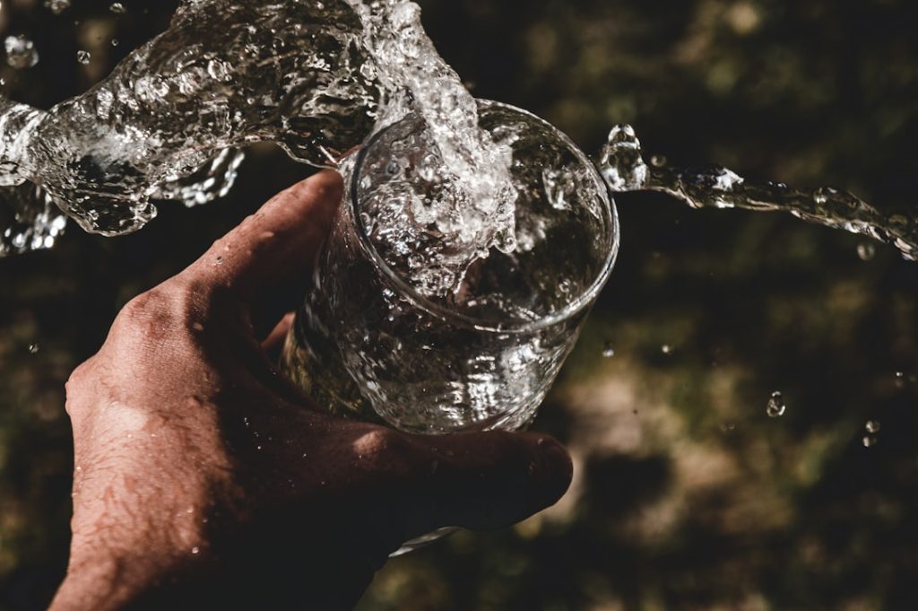 person-holding-drinking-glass-filled-with-water-klwak-fdeia
