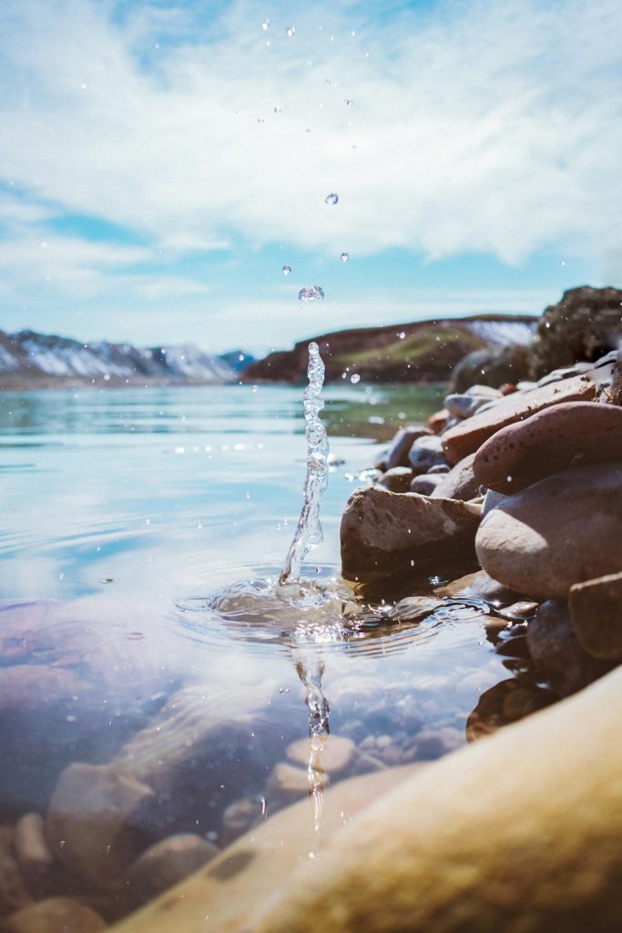 water-splash-on-brown-rocks-during-daytime-vyxenu4a7mu